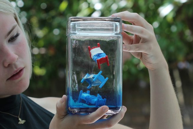 Image of girl looking at one of the Live Poetry Jukebox jars